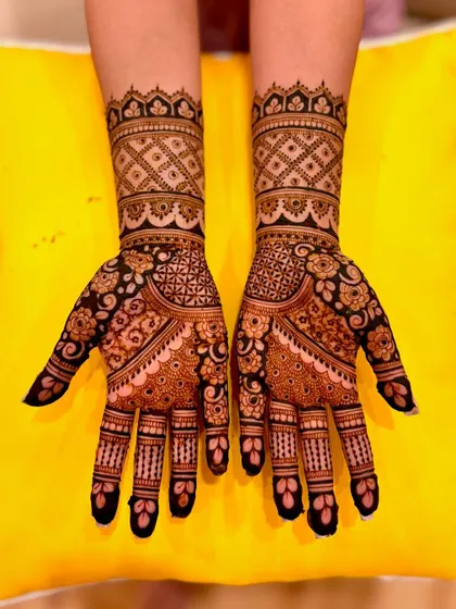 A clear, top-down view of Samiksha's detailed engagement mehendi.