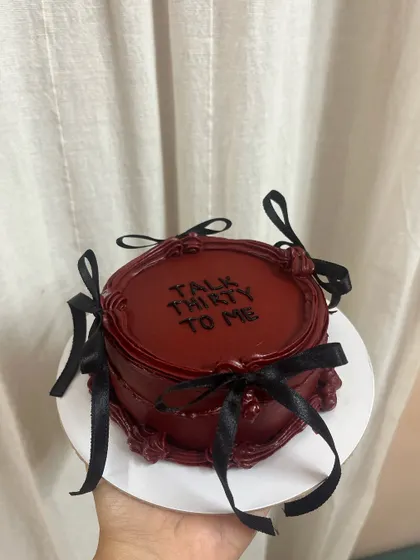 A full view of the "Talk Thirty To Me" cake. The rich color, vintage piping, and black bows make it a perfect statement piece for a milestone birthday.
