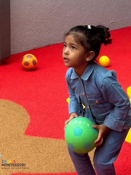 A new child enjoys the play area, getting comfortable in her new environment through the universal language of play.