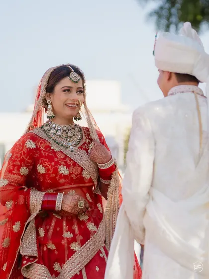 The bride's joyful smile as she sees her groom at the altar. A candid moment of pure happiness.
