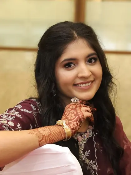 A close-up portrait that captures the soft, glowing details of her engagement makeup.