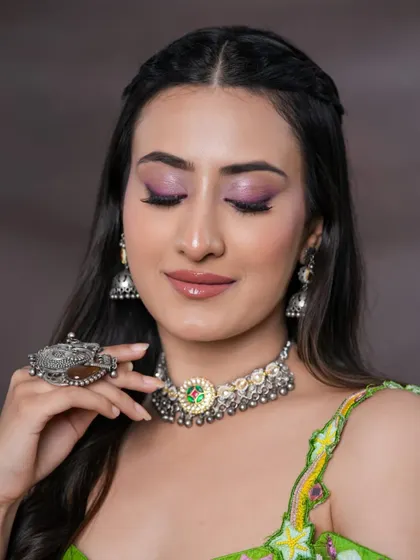 A closer look at the pink winged liner and shimmery purple eyeshadow. This is a creative and colorful eye look for someone who loves to experiment.