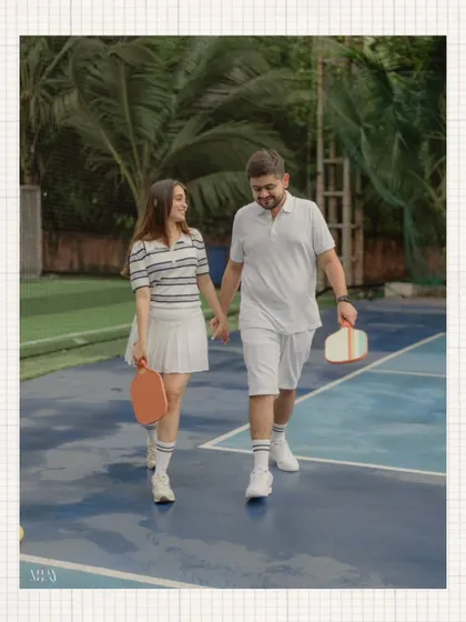 A candid walking shot of the couple on the pickleball court, paddles in hand, showcasing their coordinated outfits.