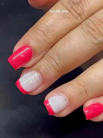 A modern twist on the French manicure with a pop of pink and a glitter ombré accent.