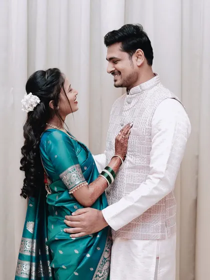 A romantic pose from an engagement, with the couple embracing and looking at each other.