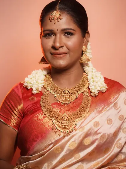 A full view of the TBO signature South Indian bridal look. The makeup perfectly complements the rich silk saree and temple jewelry.