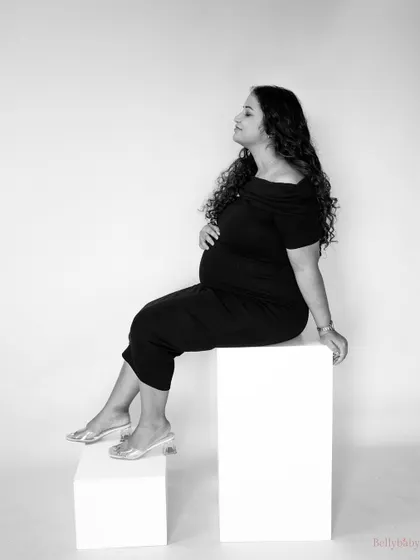 A timeless black and white portrait, showcasing her beautiful profile and the elegance of the moment. The use of simple props like blocks adds a modern touch.