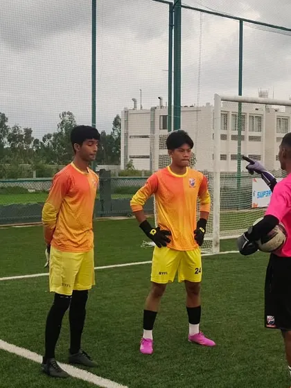 Our goalkeeping coach giving instructions to his keepers before a match. Specialized coaching is a key part of our program.