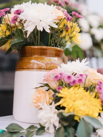 Another angle of the beautiful, rustic floral centerpieces used for the Mehendi decor, showcasing a mix of chrysanthemums, roses, and daisies.