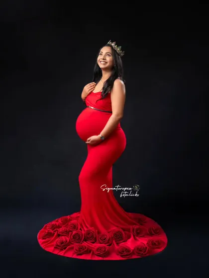 A classic, elegant portrait in a red gown with a rose-detailed train, perfect for a timeless look.