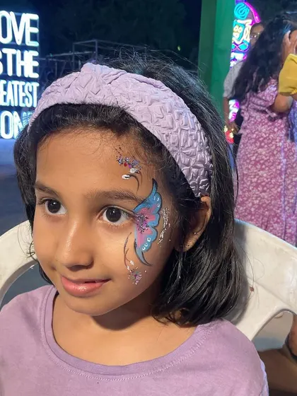 A sweet butterfly design that complements this little girl's lavender-colored outfit perfectly.