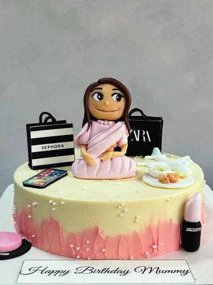 A cake that celebrates everything Mom loves! This custom design features her favorite things: shopping at Zara and Sephora, her phone, and a plate of her favorite food.