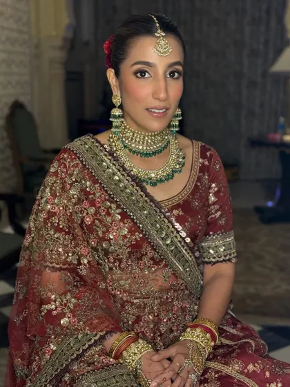 This seated portrait shows the intricate details of the bride's makeup and jewelry. I used a soft contour and highlight to define her features, ensuring she looked perfect from every angle.
