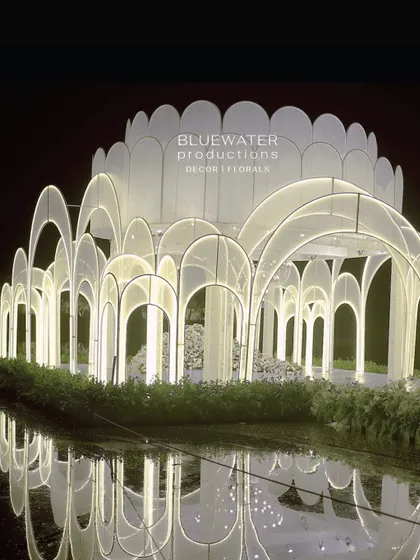The 'Floating Palace' by night, a 36-foot wide, 22-foot tall structure of lace-clad arches that we designed and fabricated to sit on the lake, creating a stunning reflection.