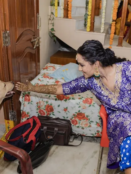 Even the furry family members are part of the celebration. A sweet moment between the bride and her dog during the Mehendi.