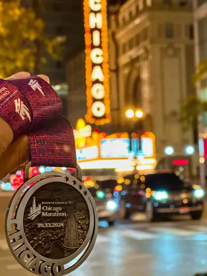 The reward for months of dedication. Holding the Chicago Marathon medal against the city's iconic backdrop is a reminder of what's possible. This is the kind of unforgettable moment we train for.