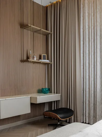 A closer look at the details in the daughter's bedroom. The custom bedside table with its fluted design, the hanging pendant light, and the elegant study nook with a wooden slatted wall all contribute to a space that is both youthful and sophisticated.