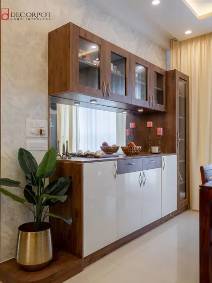 This crockery unit combines a rich wood frame with high-gloss white shutters. The mirrored back and glass shelves make it a perfect display case for fine dinnerware.