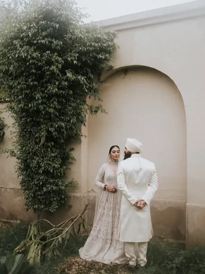 A candid moment between the couple against a simple, architectural backdrop. We believe in finding the perfect spots for photography within the venues we decorate.