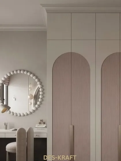 A detail shot of the arched and fluted wardrobe doors, showcasing the custom craftsmanship and high-quality materials we use in our projects.