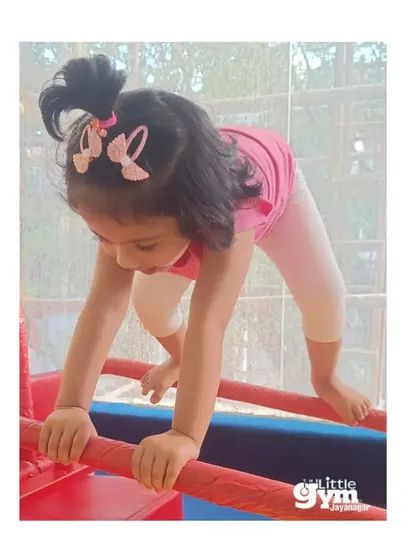 This young gymnast is carefully navigating the bars, building coordination, strength, and confidence with each movement.