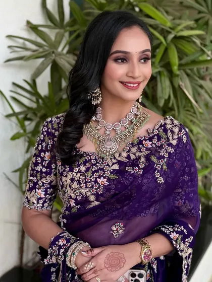 A beautiful smile from this client, ready for a reception. Her makeup features a soft glam eye and a bright lip, paired with romantic curls.