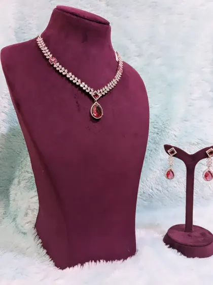 This AD necklace with red stones can be layered with other pieces or worn alone for a chic and simple statement.