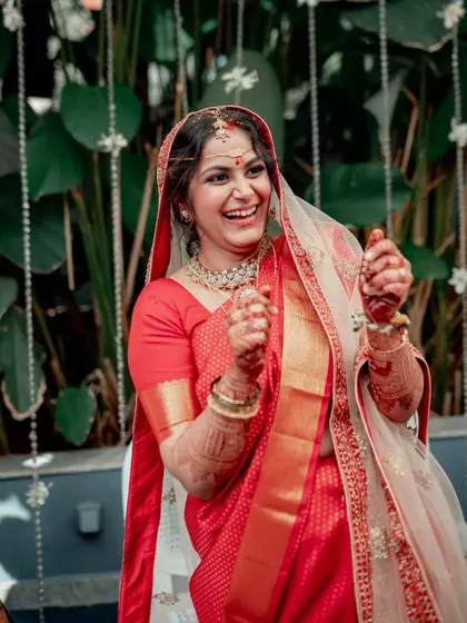 A candid photo of a bride's genuine, joyous laughter during her wedding ceremony.
