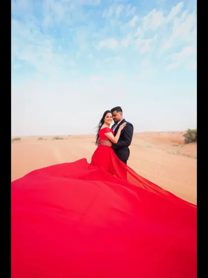 A dramatic pre-wedding photo from the Dubai desert. We work with couples planning destination weddings around the globe, helping them create stunning visuals and memories.