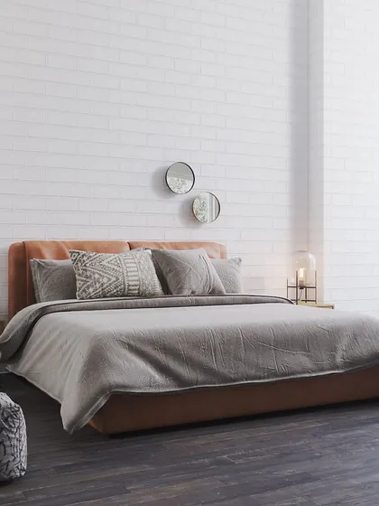 A bedroom that feels like a sanctuary, featuring one of our luxurious leather beds. The warm tones and plush bedding create a cozy oasis, inviting you to unwind in ultimate comfort.