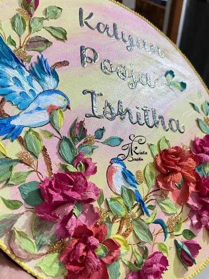 An angled view of the circular nameplate, capturing the shimmer of the silver-lined names.