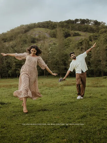 A joyful and energetic photo of a couple running with open arms in a field, celebrating their love.