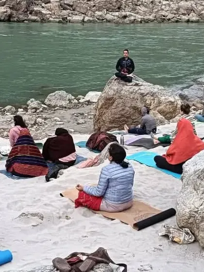 Finding stillness amidst the stones. Our students practicing meditation by the river, learning to find their center in any environment.