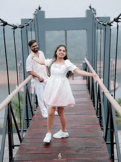 A happy, carefree pose on the bridge, with her arms outstretched as if embracing the moment.