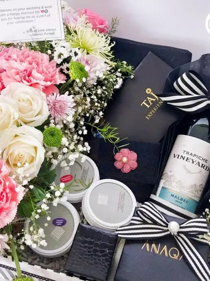 Regal romance in a box. This hamper is curated with a bottle of fine wine, gourmet snacks, and beautiful floral arrangements, perfect for a couple who appreciates the finer things in life.