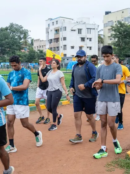 Photos from the trial run for the Lotus Freedom Run 2023 at Sarakki Lake, showing participants warming up and running together.