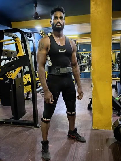 Another look at a lifter in full competition gear. The belt, sleeves, and singlet are the tools of our trade.