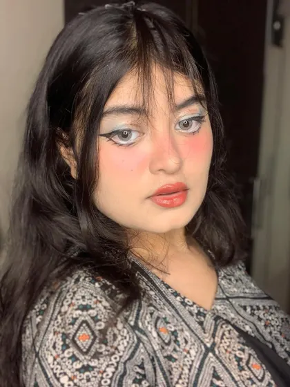 Another view of the doll-like makeup, highlighting the unique eyeliner style.
