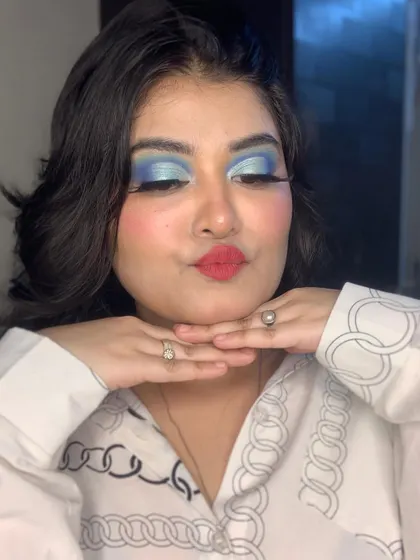 A playful pose showing off the blue eye makeup.