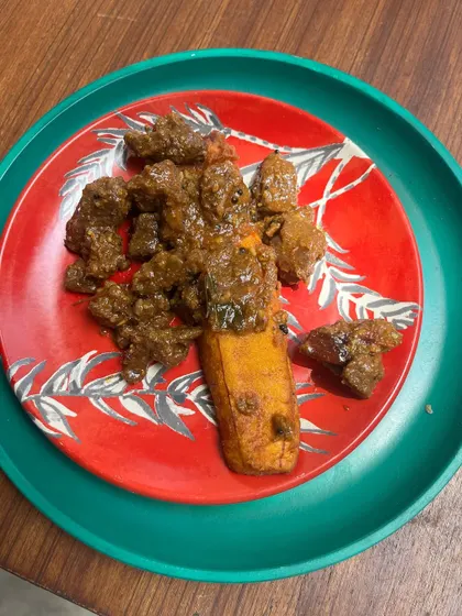 A plate of Pazham Pori and Buff Roast. The sweetness of the fried plantain cuts through the rich, spicy gravy of the buff roast, creating a flavor explosion that is pure Kerala swag.