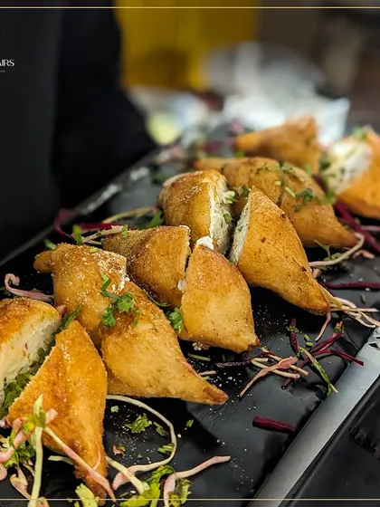 These crispy fried pockets are filled with a savory paneer mixture. They are a perfect example of a modern take on a classic Indian snack, ideal for high-tea or as a party starter.