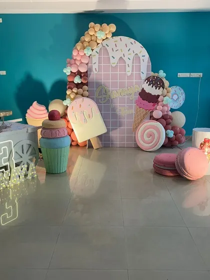 A super sweet ice cream and candy land theme, with giant props of popsicles, macarons, and cupcakes.