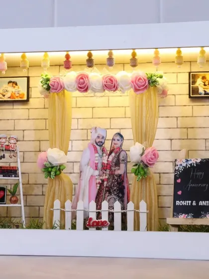 This anniversary-themed miniature box features a beautiful wedding stage setup with drapes, flowers, and a 'Happy Anniversary' sign.