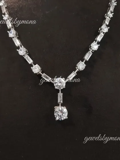 A detailed look at the pendant drop of the diamond tennis necklace. The combination of round and baguette diamonds creates a beautiful texture and maximizes the brilliance of the piece.