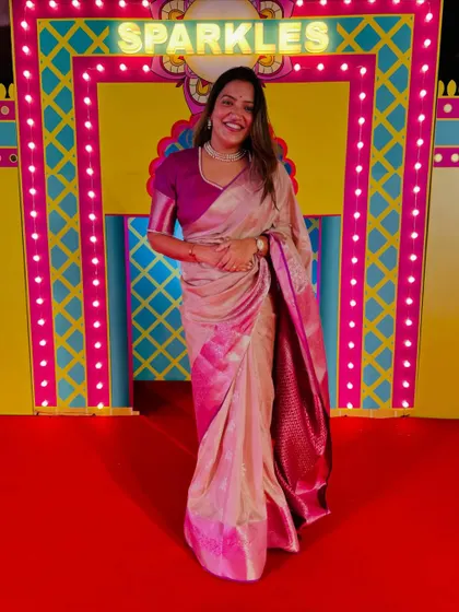 Sparkle and shine, it's Diwali time! Dressed in a festive pink and beige saree for a special celebration.