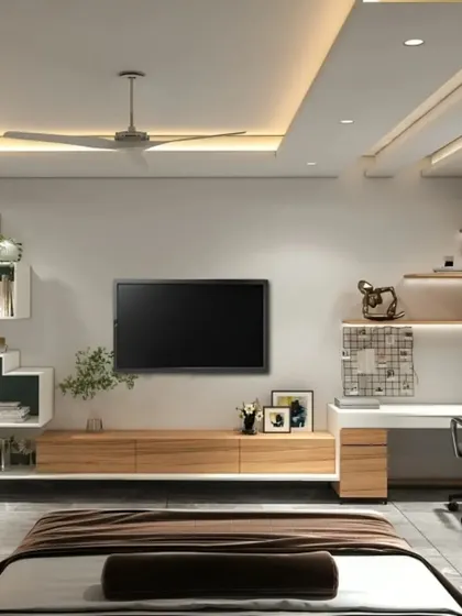 This multifunctional room design combines a bedroom with a workspace. The TV is mounted above a long, floating wooden console that extends to become a study desk, maximizing utility in a single space.