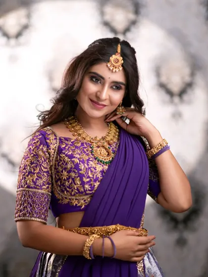 A close-up of the exquisite gold embroidery on the blouse of our purple half saree. This level of detail adds a luxurious touch to your traditional look.