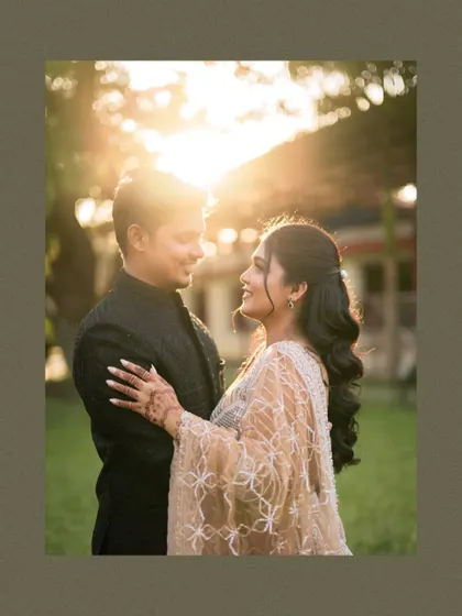 A beautiful backlit engagement portrait of the couple gazing at each other, with the sun creating a lovely flare.