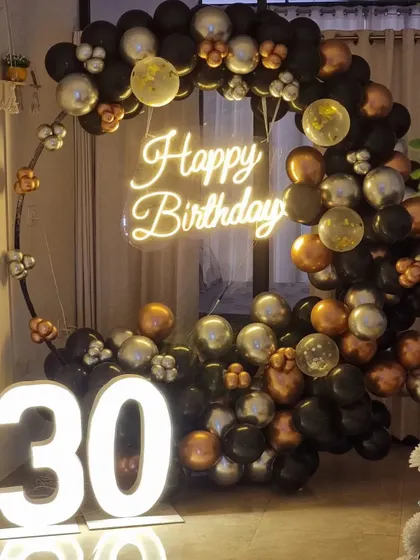 A sophisticated ring setup for a 30th birthday, using a modern color palette of black, silver, and rose gold.