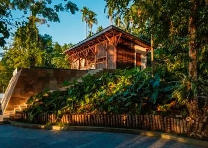 The restaurant pavilion at Jalakara, perched on a stone plinth and surrounded by tropical vegetation.